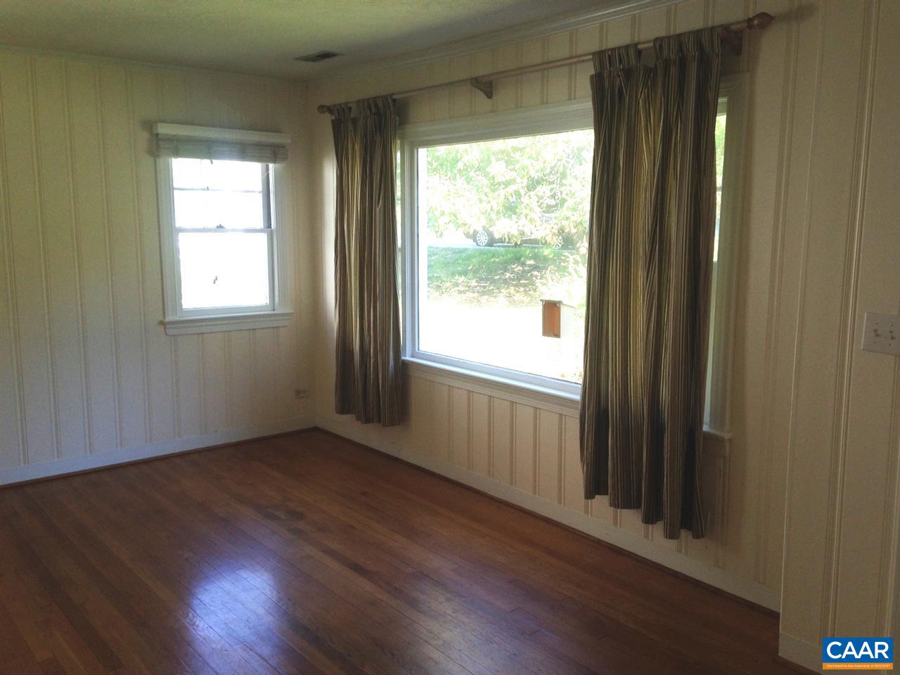 219 Shamrock Road Charlottesville, VA 22903 - Photo 4 of 12 a view of an empty room with wooden floor and a window