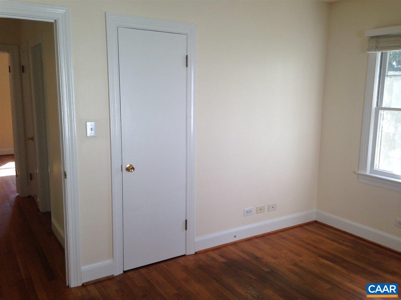 219 Shamrock Road Charlottesville, VA 22903 - Photo 10 of 12 an empty room with wooden floor and windows