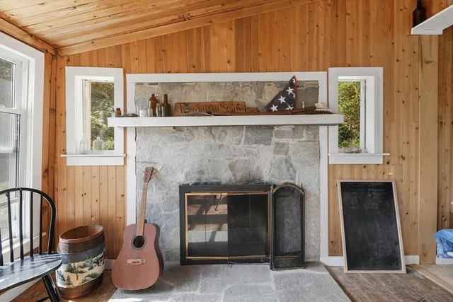 a kitchen with a fireplace and cabinets