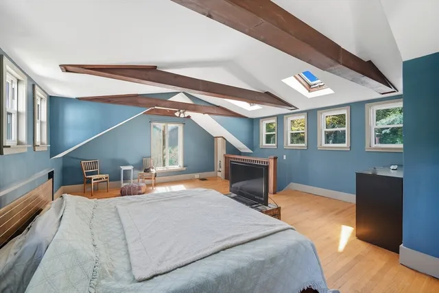 a bedroom with furniture and a fireplace