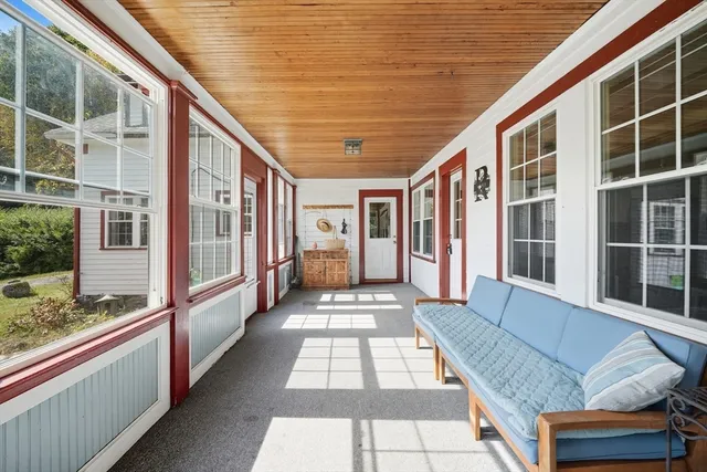 a view of balcony with wooden floor and furniture
