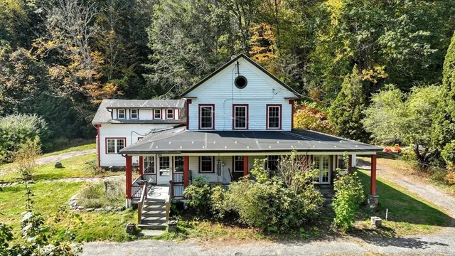 a view of a house with yard and sitting area