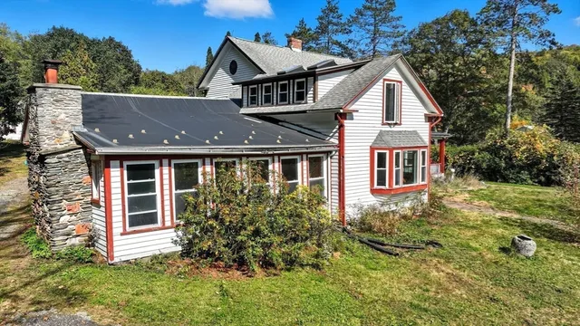 a aerial view of a house next to a yard