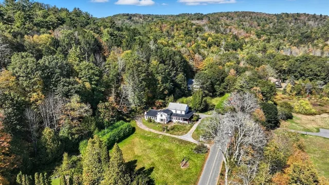 swimming pool view with a garden view