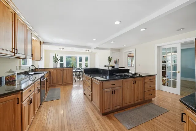 a kitchen with stainless steel appliances granite countertop a stove and a sink