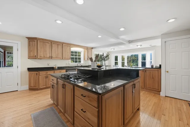 a kitchen with granite countertop a sink and cabinets