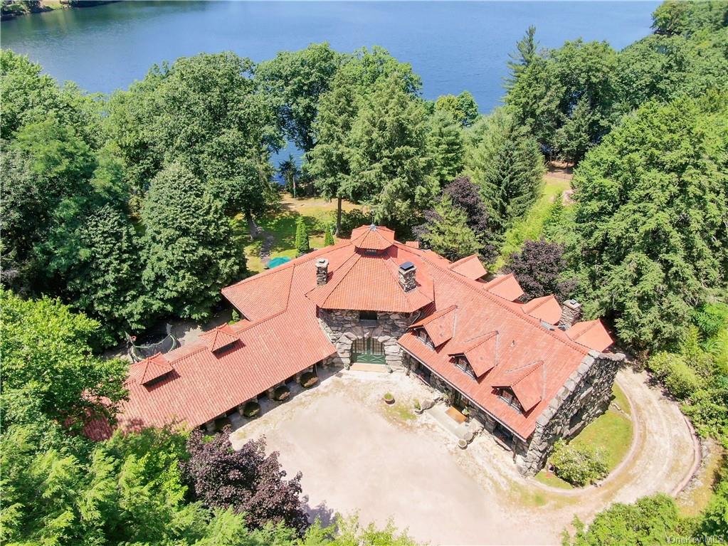 an aerial view of a house with a swimming pool and garden