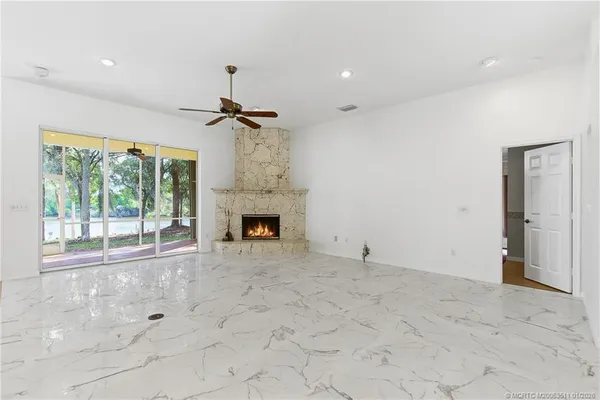 a view of empty room with a fireplace