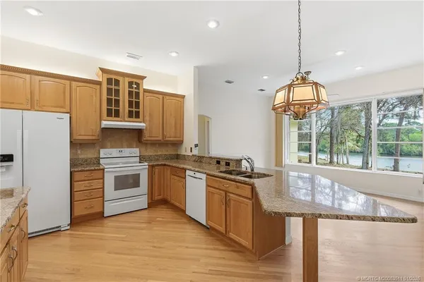 a kitchen with stainless steel appliances granite countertop a stove and a refrigerator