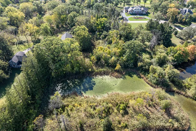 an aerial view of residential house with outdoor space and swimming pool