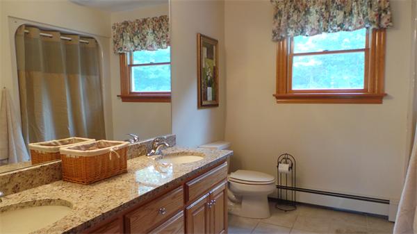 19 Carter Road Foxboro, MA 02035 - Photo 25 of 30 a bathroom with a granite countertop toilet a sink and a window
