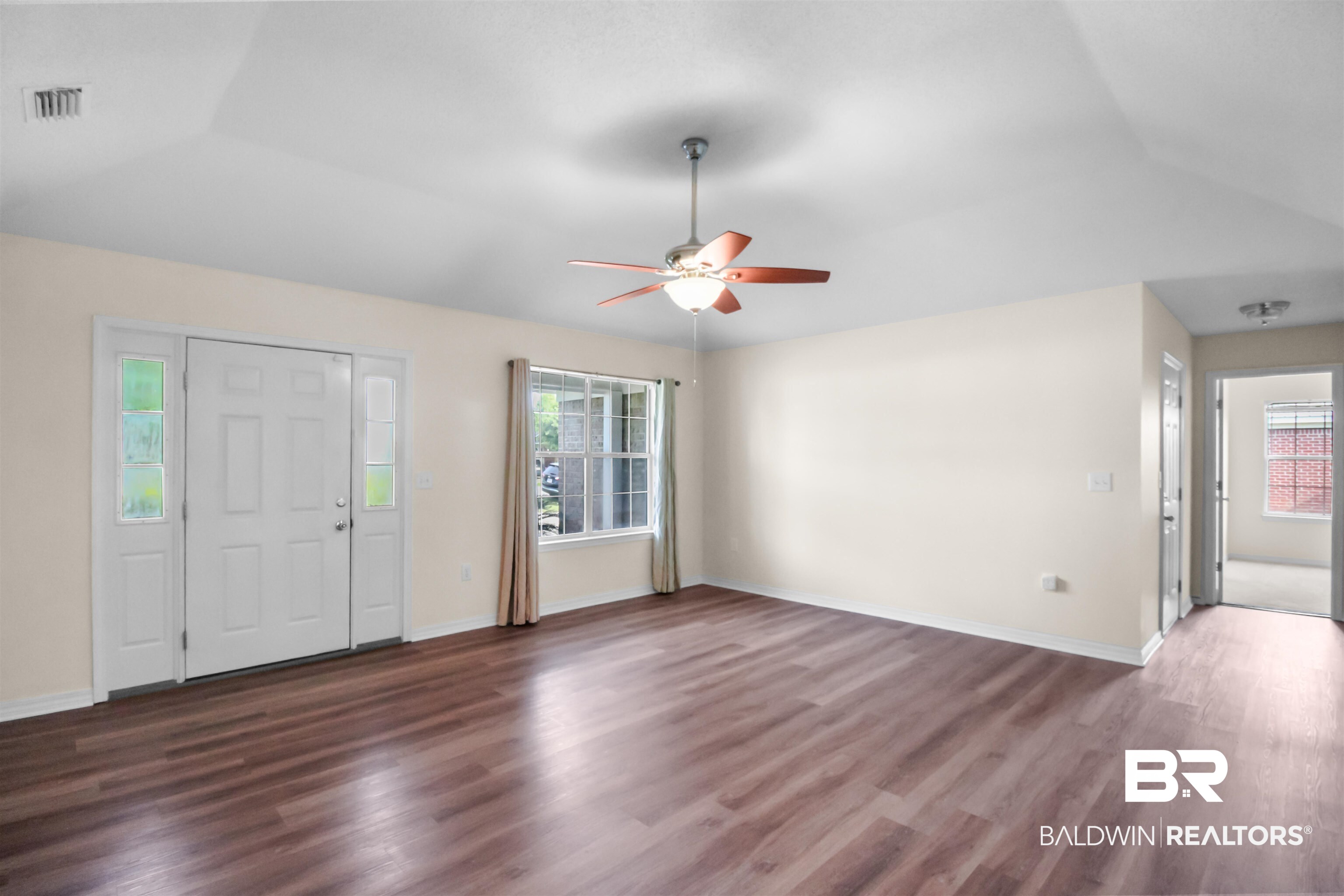 8940 Caitlin Street Foley, AL 36535 - Photo 5 of 27 Entrance foyer featuring dark wood-style floors, a ceiling fan, and vaulted ceiling