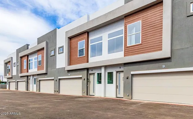 a front view of a house with a road