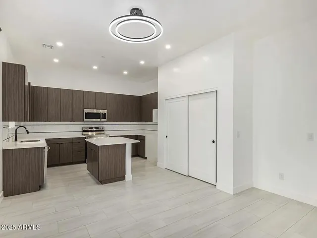 a kitchen with a sink cabinets and stainless steel appliances