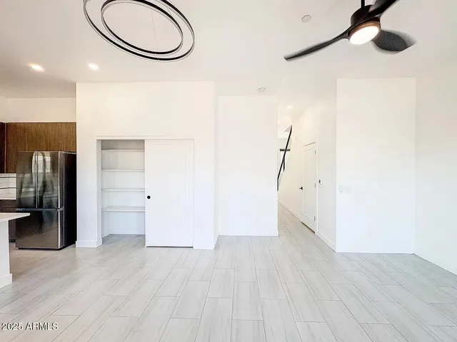 a view of a room with wooden floor and cabinets