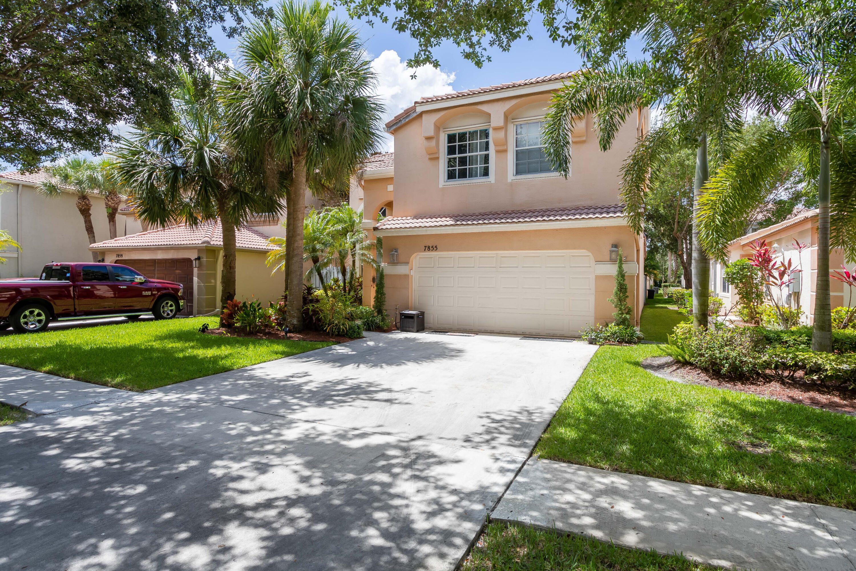 a front view of a house with a yard and a garage
