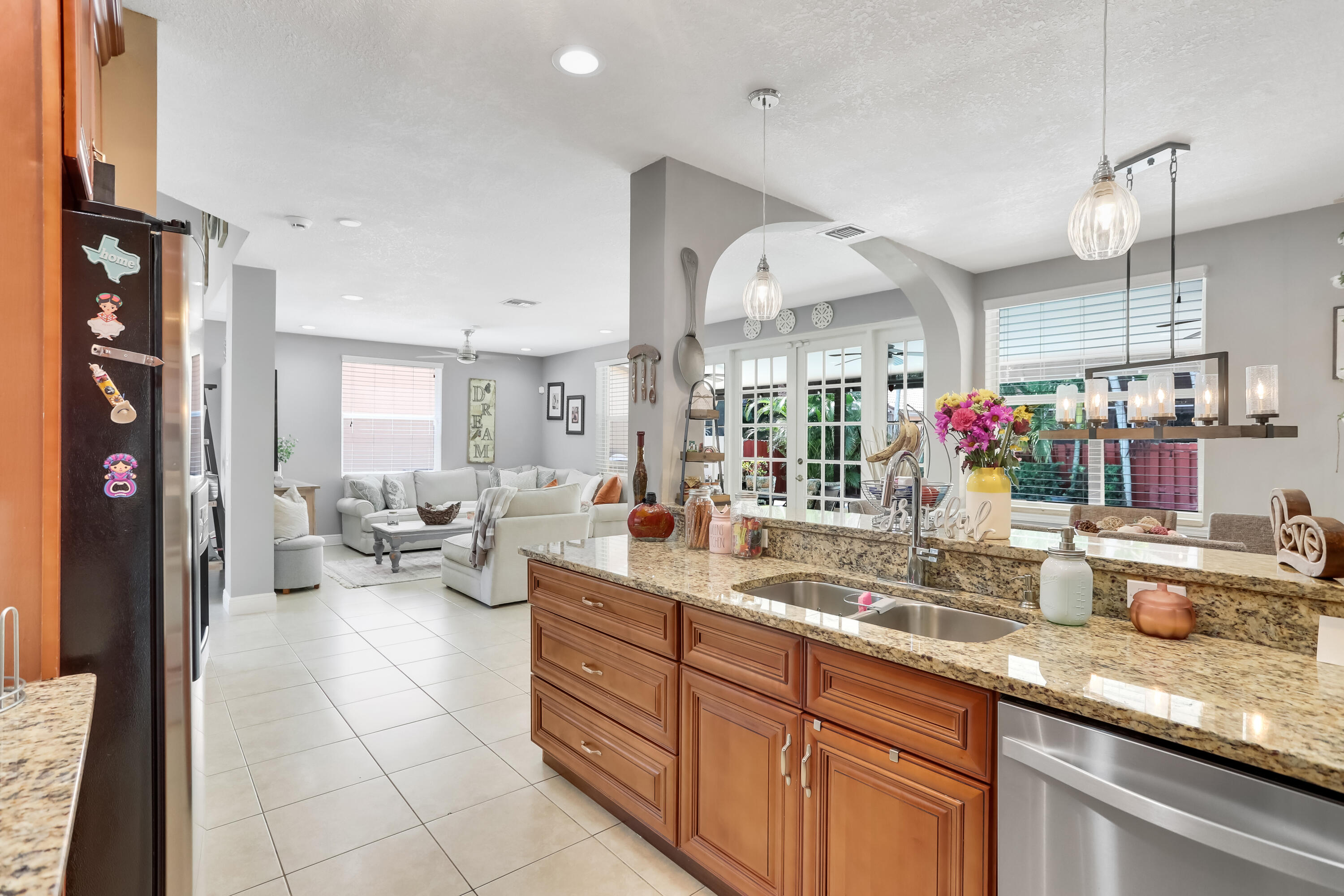 7855 Oak Grove Circle Lake Worth, FL 33467 - Photo 12 of 40 a kitchen with sink cabinets and living room view