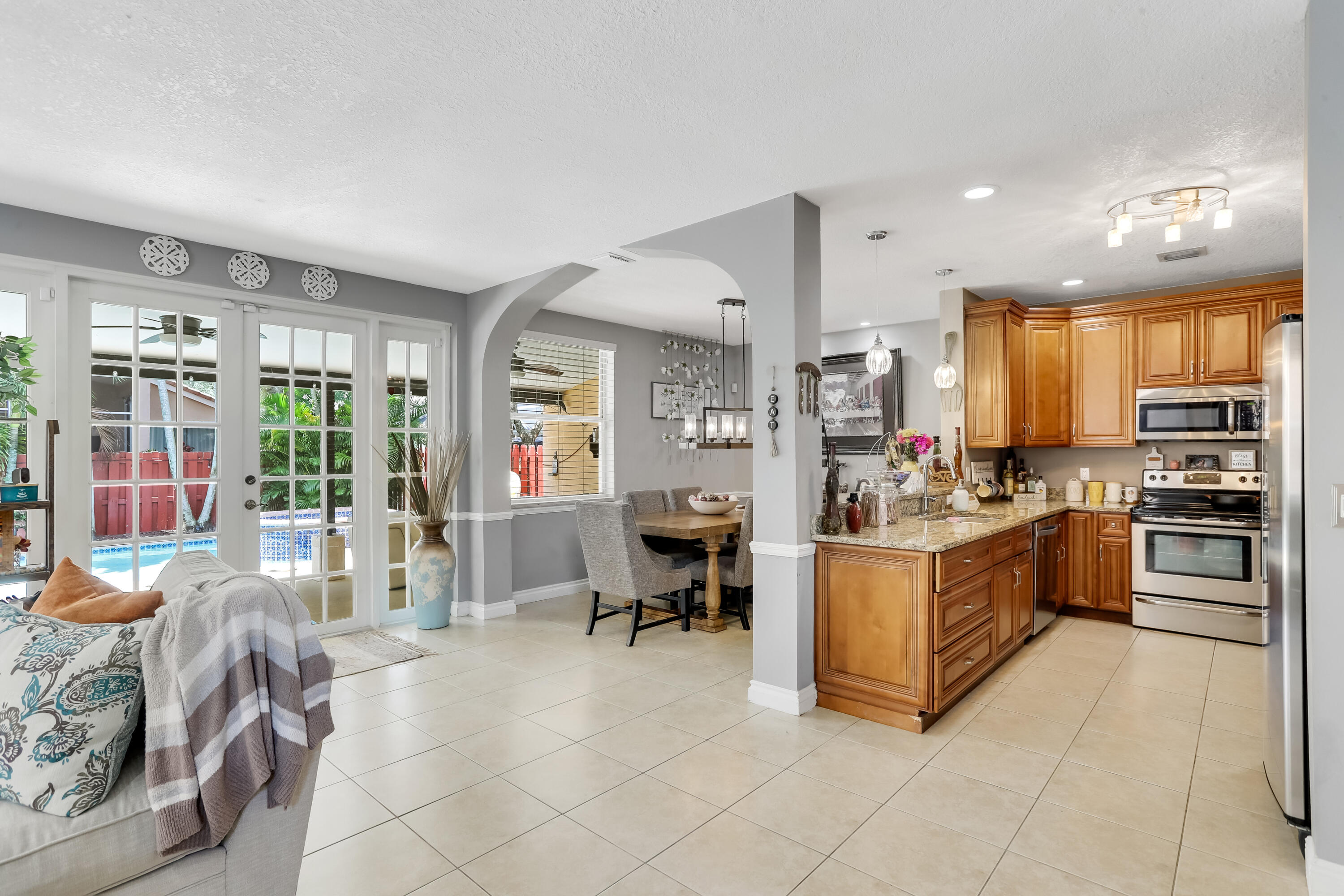 7855 Oak Grove Circle Lake Worth, FL 33467 - Photo 13 of 40 a kitchen with stainless steel appliances kitchen island granite countertop a stove and cabinets