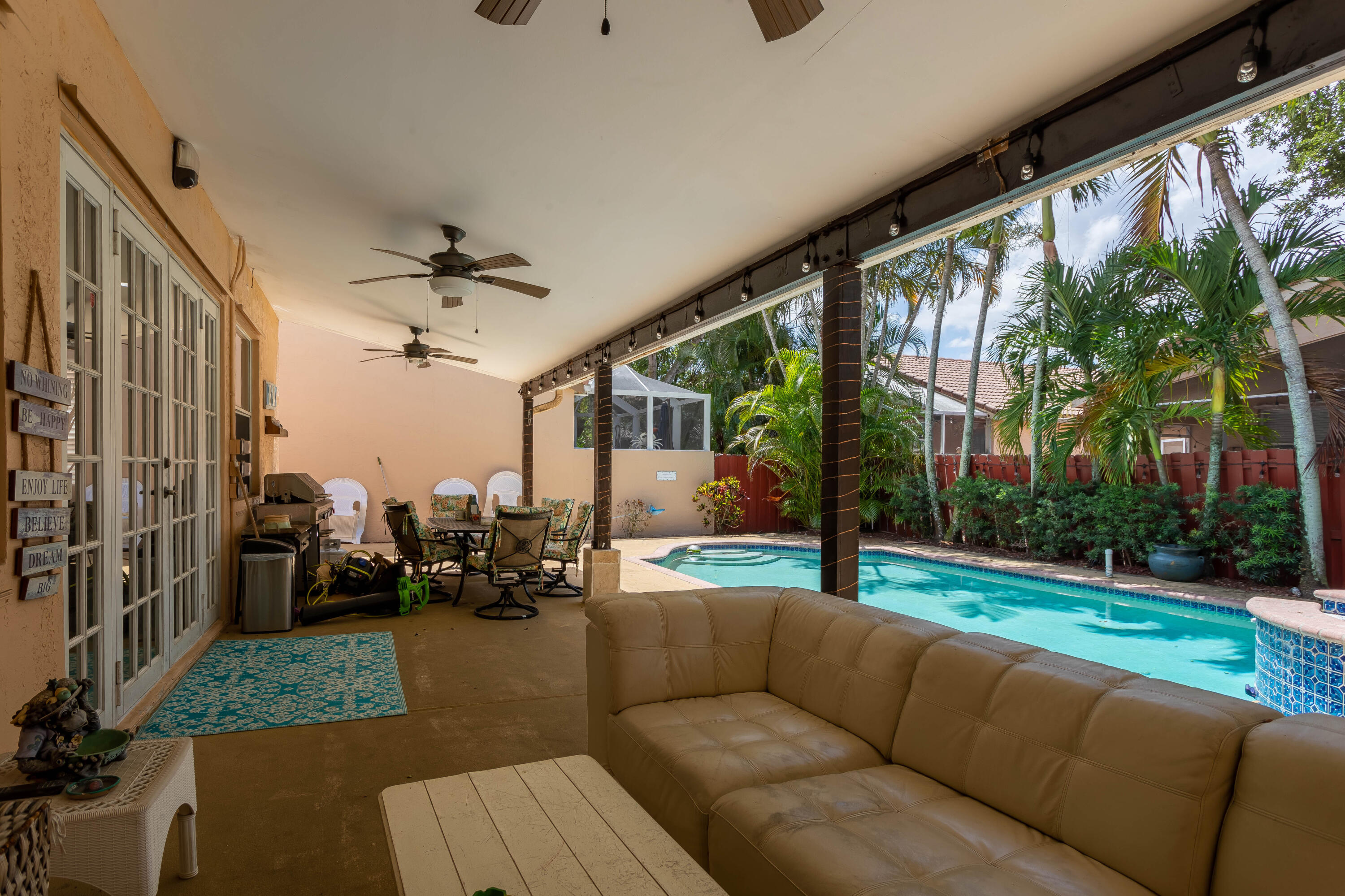7855 Oak Grove Circle Lake Worth, FL 33467 - Photo 17 of 40 a living room with patio furniture and a garden