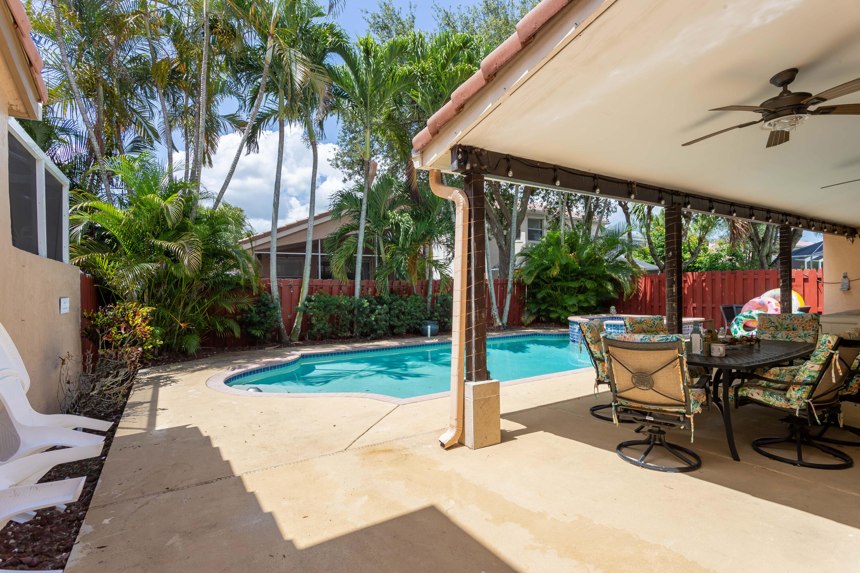 7855 Oak Grove Circle Lake Worth, FL 33467 - Photo 19 of 40 a view of a patio with a table chairs and a yard