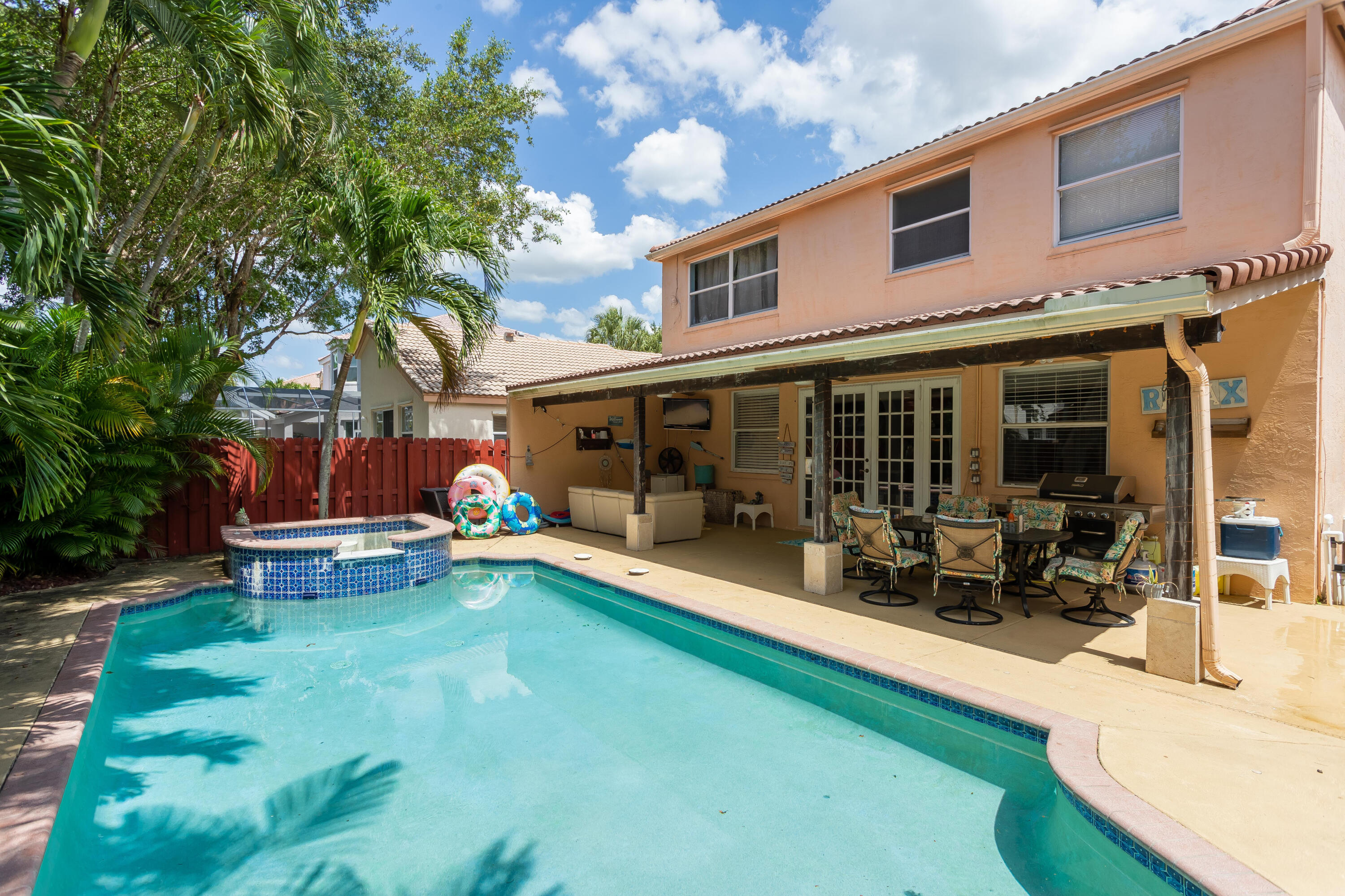 7855 Oak Grove Circle Lake Worth, FL 33467 - Photo 20 of 40 a view of a house with a backyard patio and sitting area