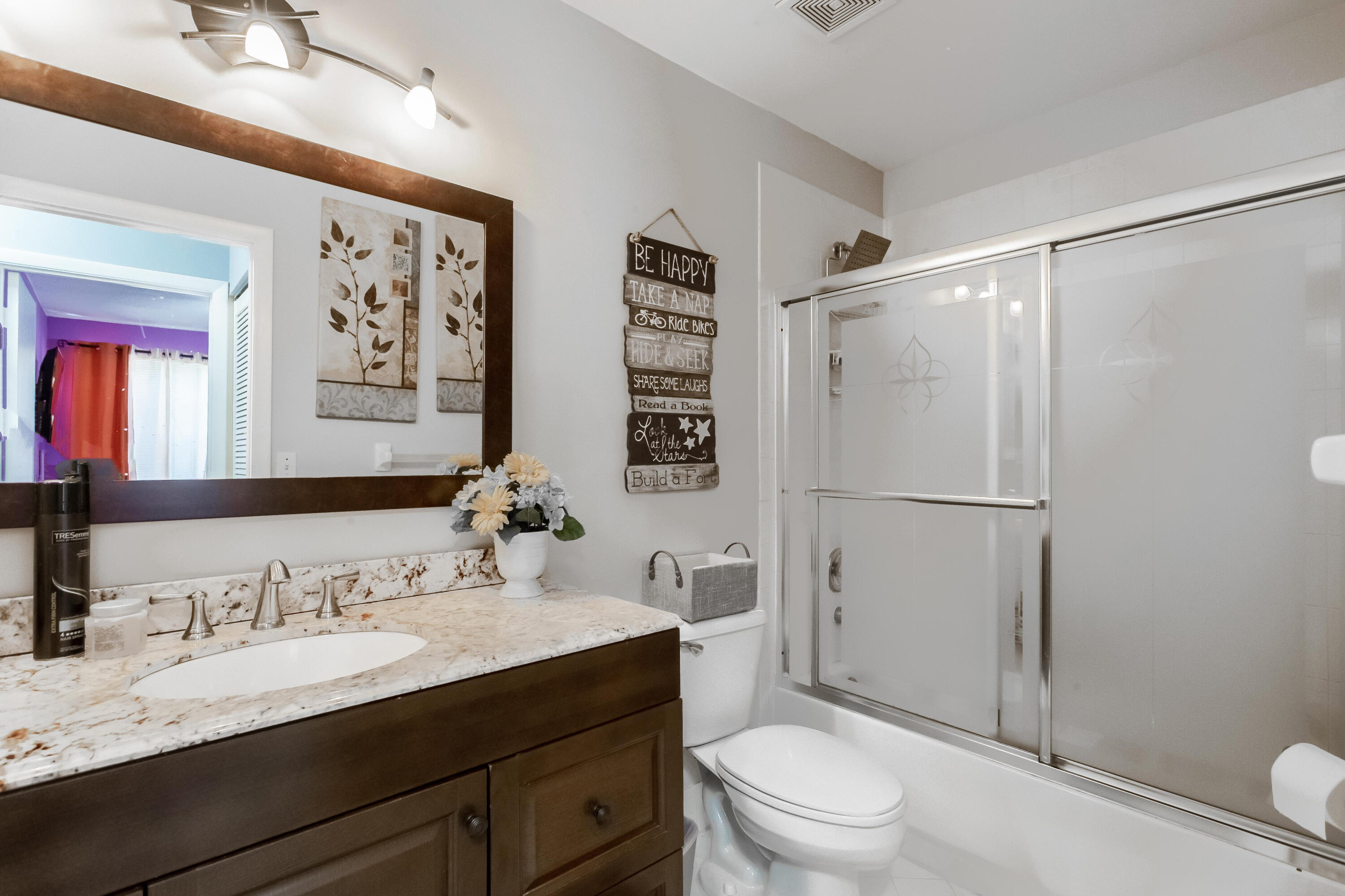 7855 Oak Grove Circle Lake Worth, FL 33467 - Photo 24 of 40 a bathroom with a granite countertop sink toilet and shower