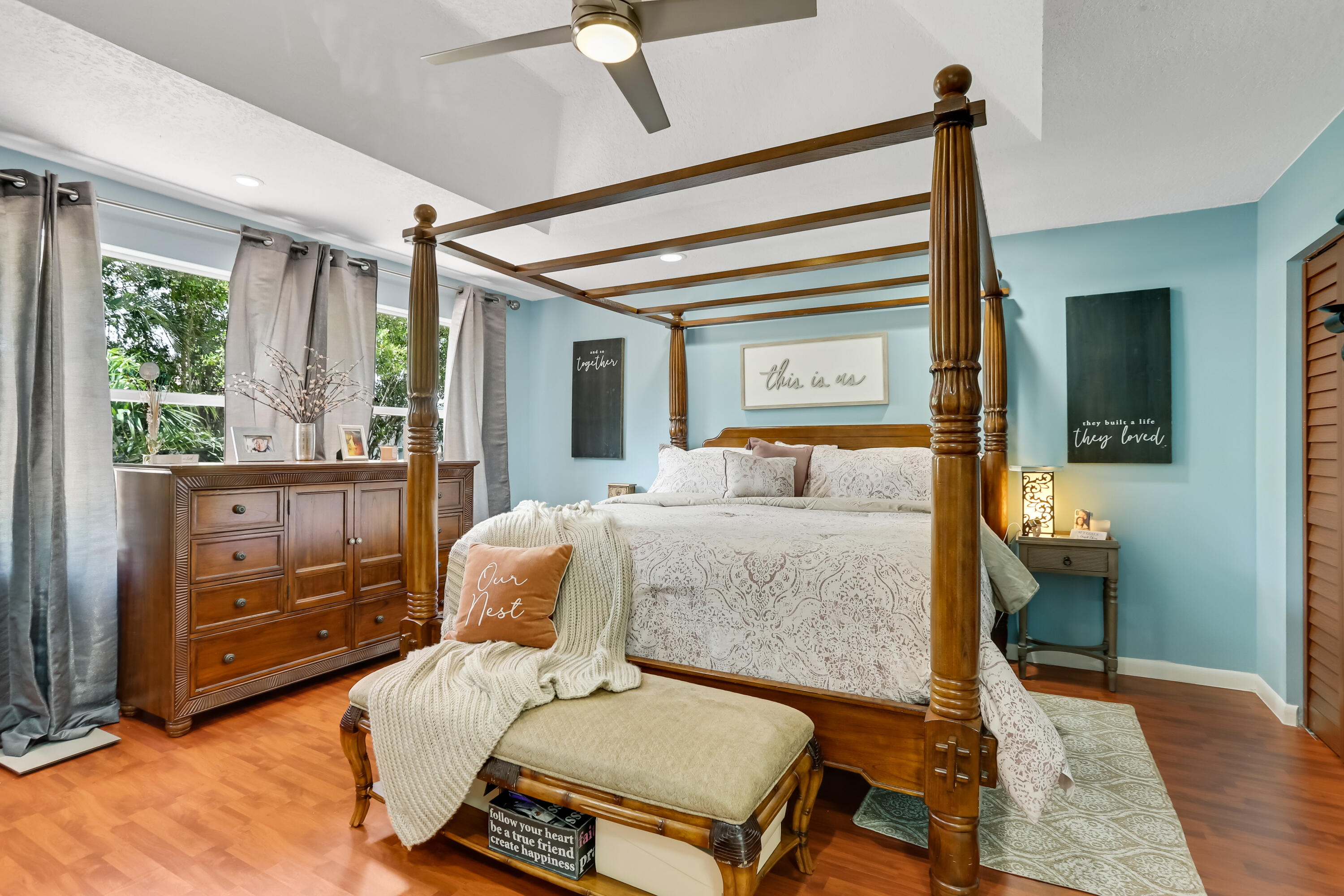 7855 Oak Grove Circle Lake Worth, FL 33467 - Photo 28 of 40 a bedroom with a bed and wooden floor