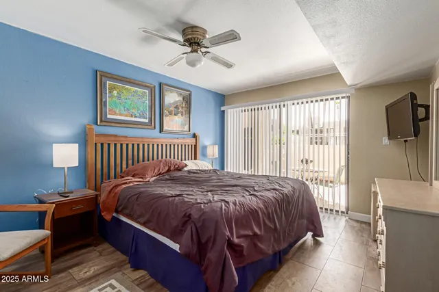 a bed sitting in a bedroom next to a window