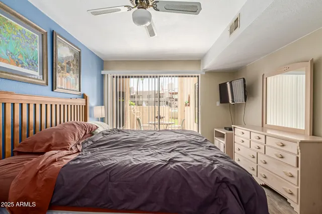 a bedroom with a large bed and a chandelier