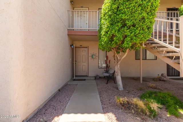 a backyard of a house with table and chairs