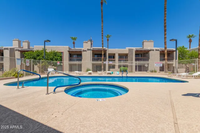 a swimming pool with outdoor seating and yard