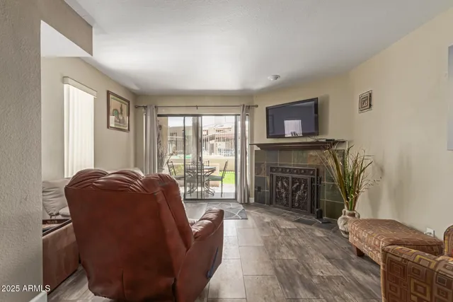 a living room with furniture a flat screen tv and a fireplace