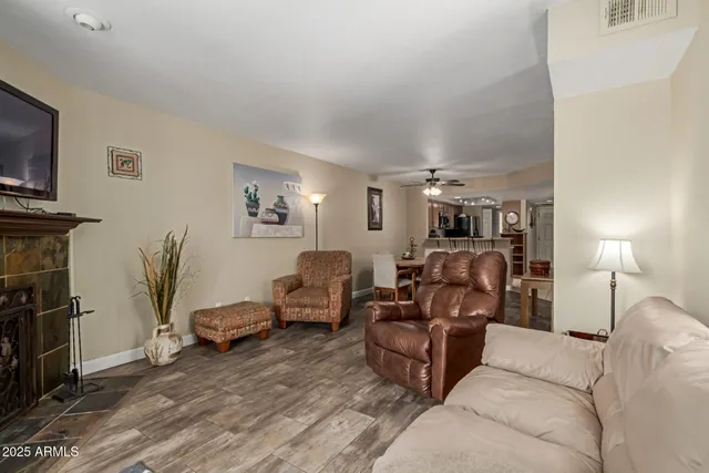 a living room with fireplace and a flat screen tv