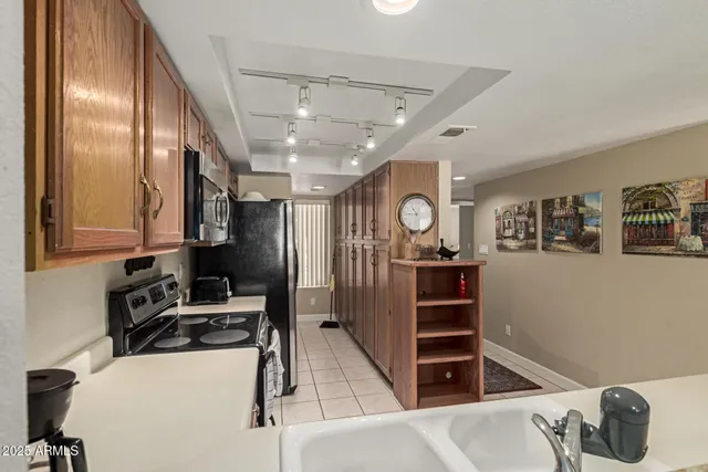 a kitchen with stainless steel appliances a stove a sink and a refrigerator