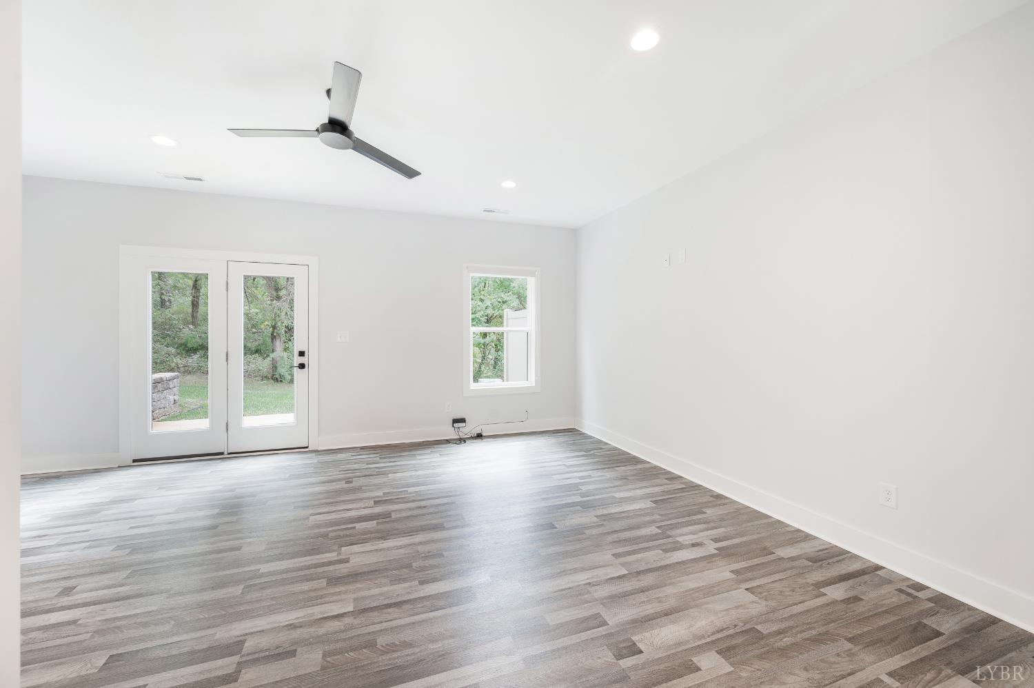 88 Allure Drive Rustburg, VA 24588 - Photo 16 of 58 an empty room with wooden floor chandelier fan and windows
