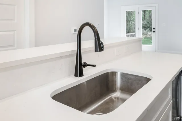 an empty room with windows and cabinet