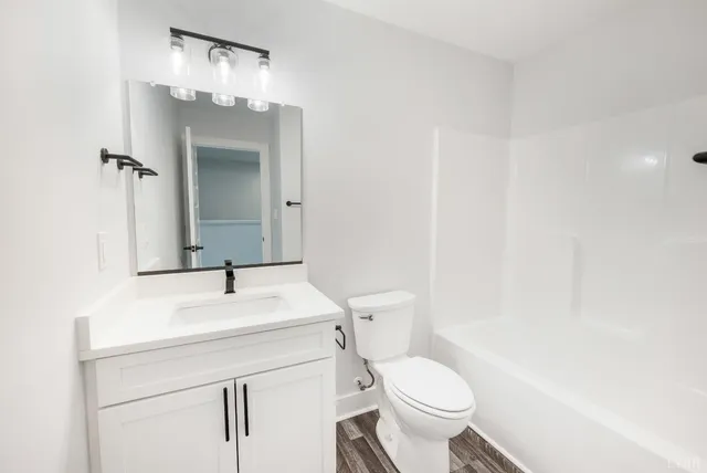 a view of a room with wooden floor