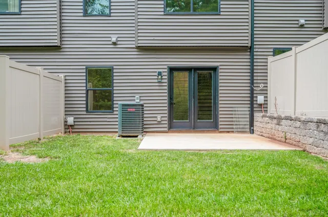 front view of a brick house with large windows