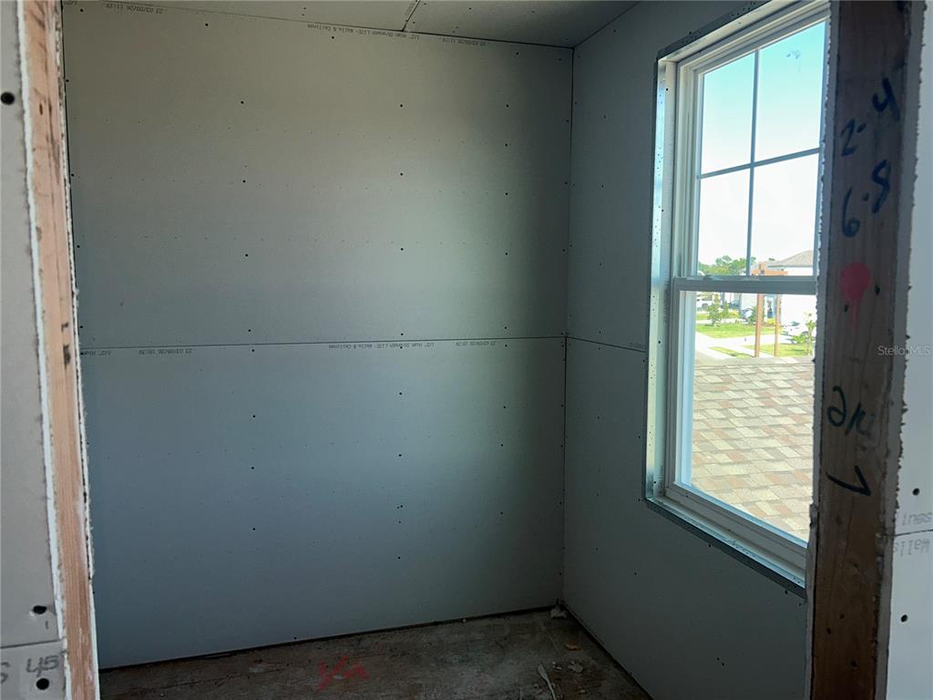 10123 Hidden Hammock Loop Parrish, FL 34221 - Photo 18 of 32 an empty room with windows