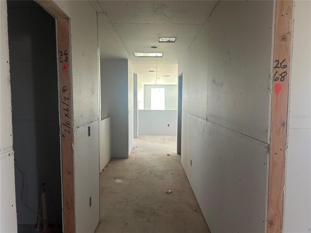 10123 Hidden Hammock Loop Parrish, FL 34221 - Photo 23 of 32 a view of a hallway with wooden shelves