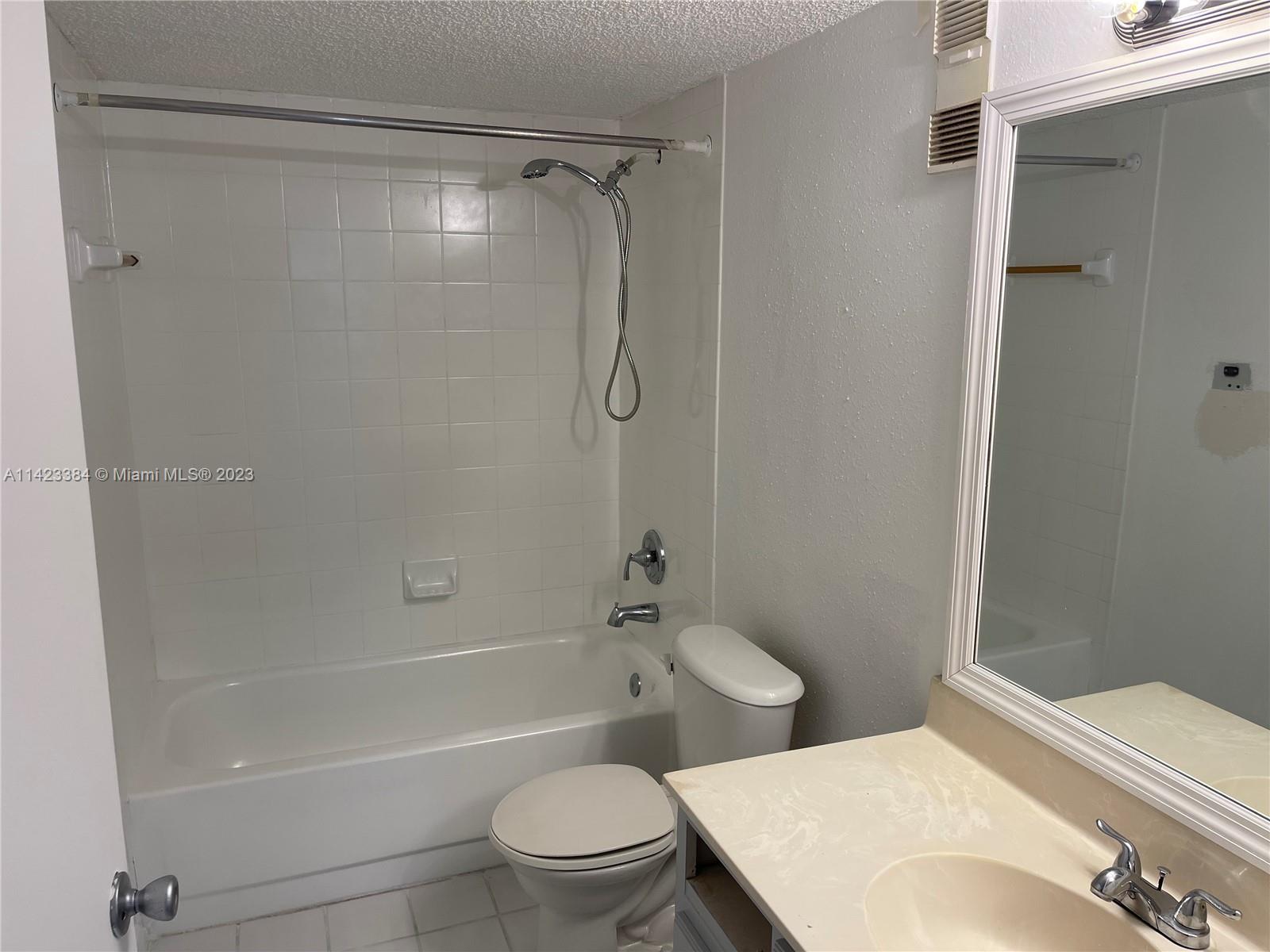 4045 West McNab Road, Unit G106 Pompano Beach, FL 33069 - Photo 11 of 23 a bathroom with a toilet and shower