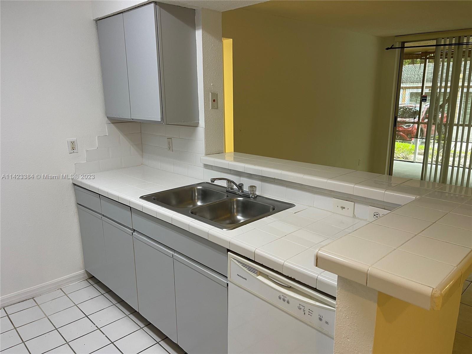 4045 West McNab Road, Unit G106 Pompano Beach, FL 33069 - Photo 17 of 23 a utility room with dryer and washer