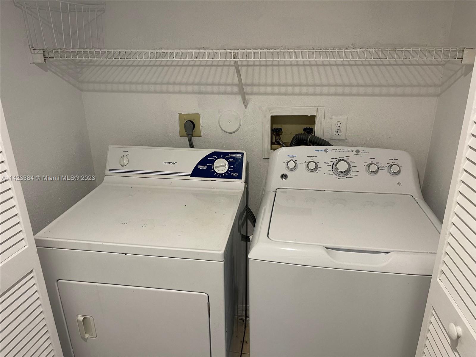 4045 West McNab Road, Unit G106 Pompano Beach, FL 33069 - Photo 18 of 23 a utility room with dryer and washer