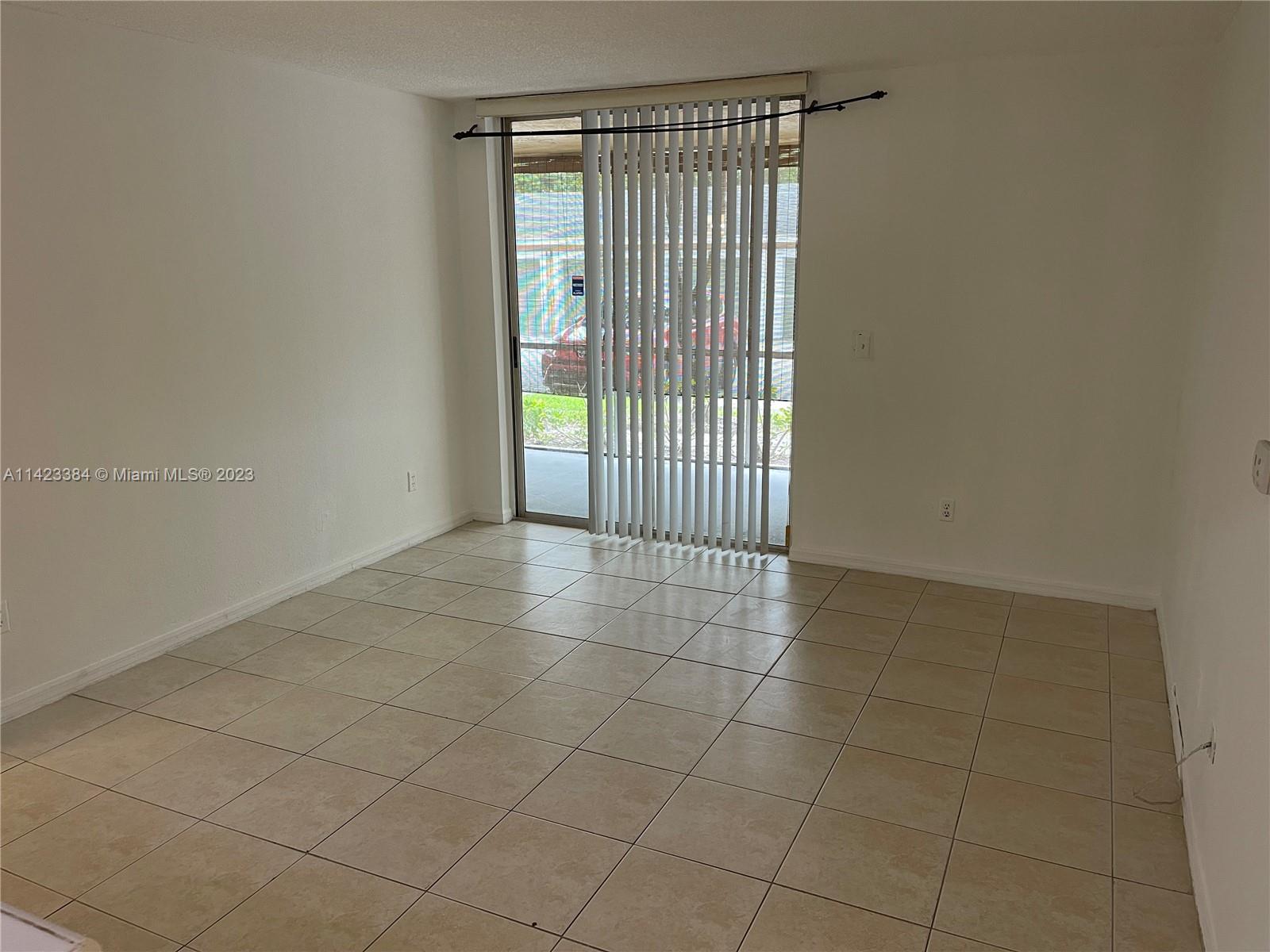 4045 West McNab Road, Unit G106 Pompano Beach, FL 33069 - Photo 6 of 23 a view of an empty room with a window