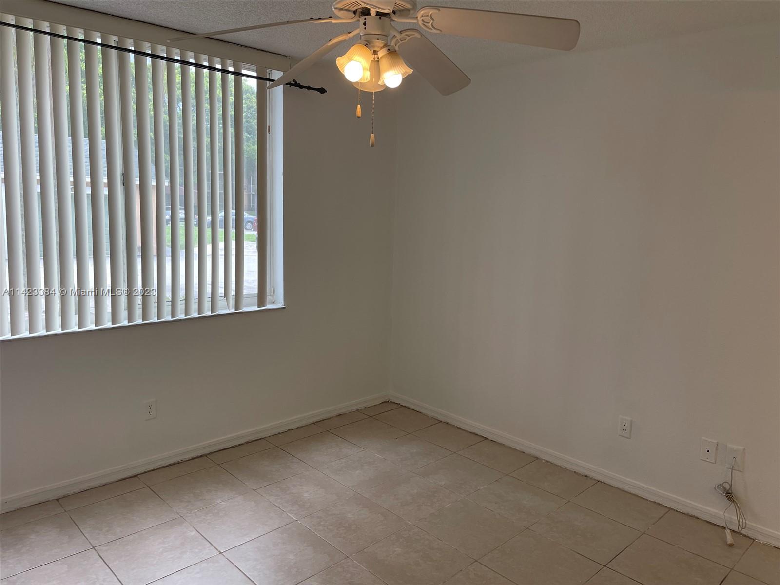 4045 West McNab Road, Unit G106 Pompano Beach, FL 33069 - Photo 8 of 23 a view of an empty room with a window