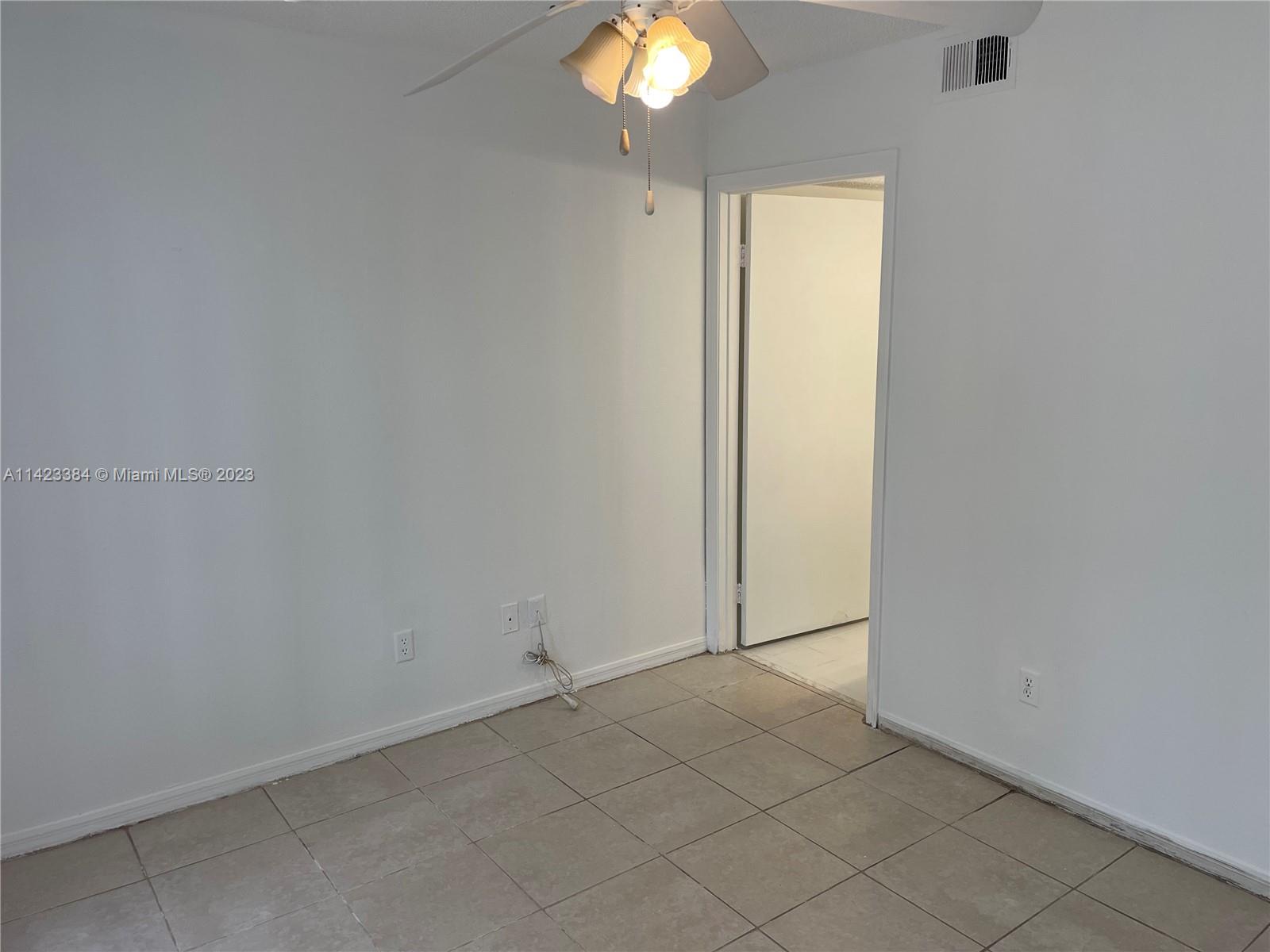 4045 West McNab Road, Unit G106 Pompano Beach, FL 33069 - Photo 10 of 23 an empty room with a bathroom