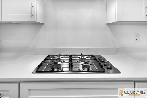 a close view of a stove a microwave and cabinets