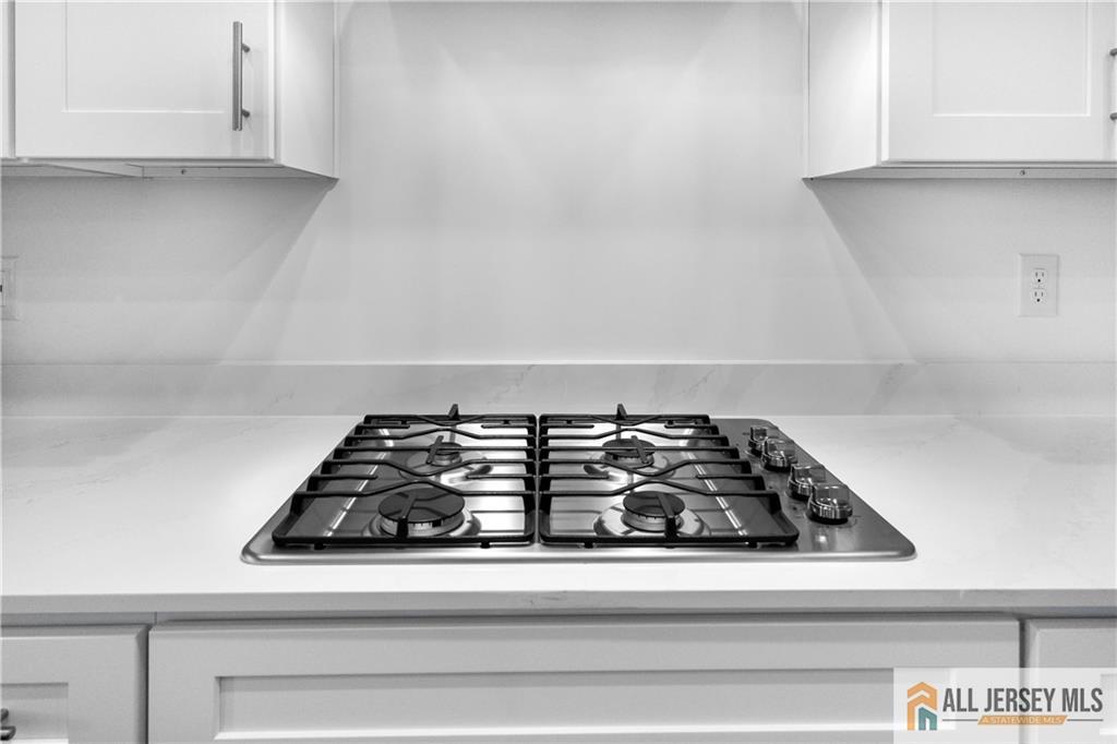 4 Prado Road Monroe Township, NJ 08831 - Photo 12 of 21 a close view of a stove a microwave and cabinets