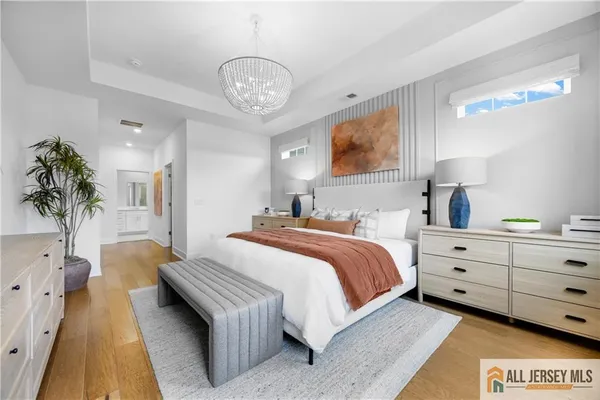 a spacious bedroom with a bed and a potted plant