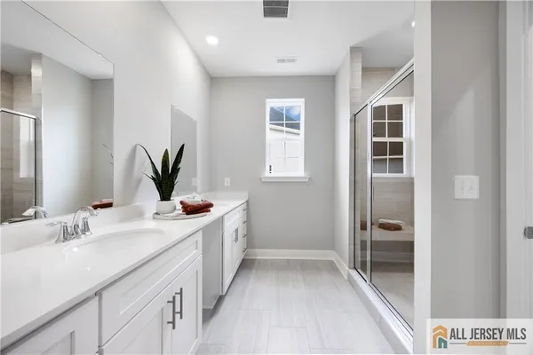 a bathroom with a double vanity sink and a mirror